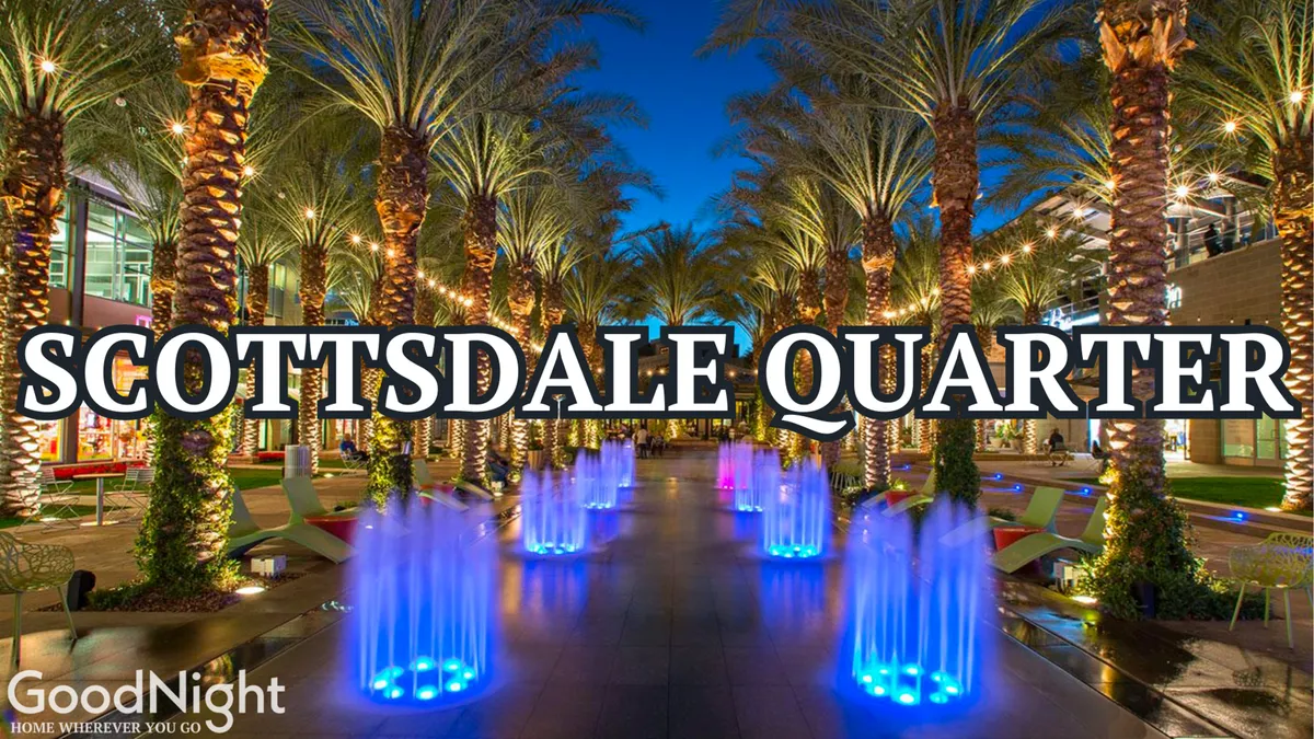 Vibrant, illuminated water fountains surrounded by palm trees and modern architecture, set against the fading evening light. The scene is alive with community energy, suggesting a lively atmosphere ideal for dining, strolling, or attending local arts events.
