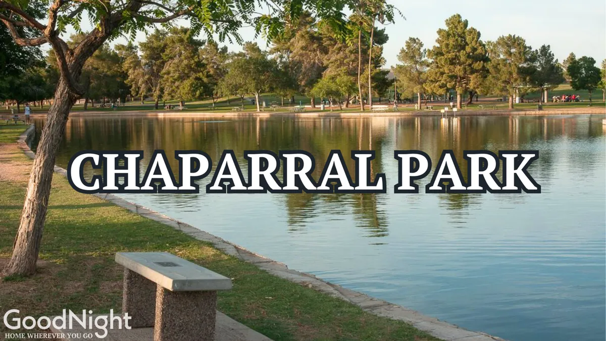A tranquil lakeside view with benches and shady trees lining the water's edge, inviting families to enjoy a picnic, a peaceful walk, or relaxed outdoor play. The serene setting reflects the accessible parks and playgrounds described in the section.